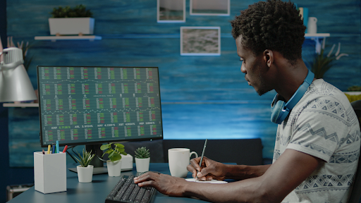 person looking at stock market trading data on computer